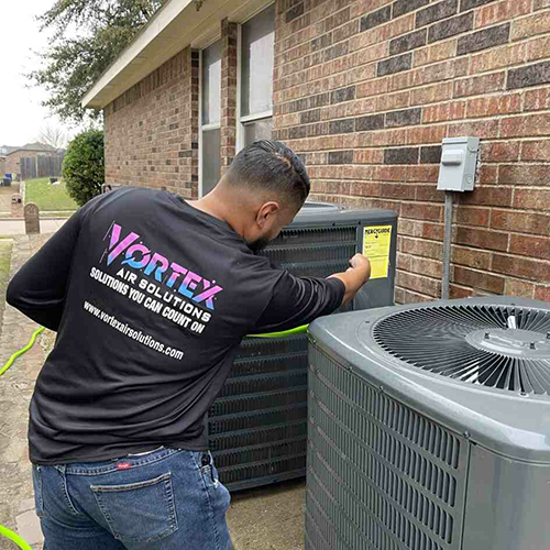 Tech work on ac unit